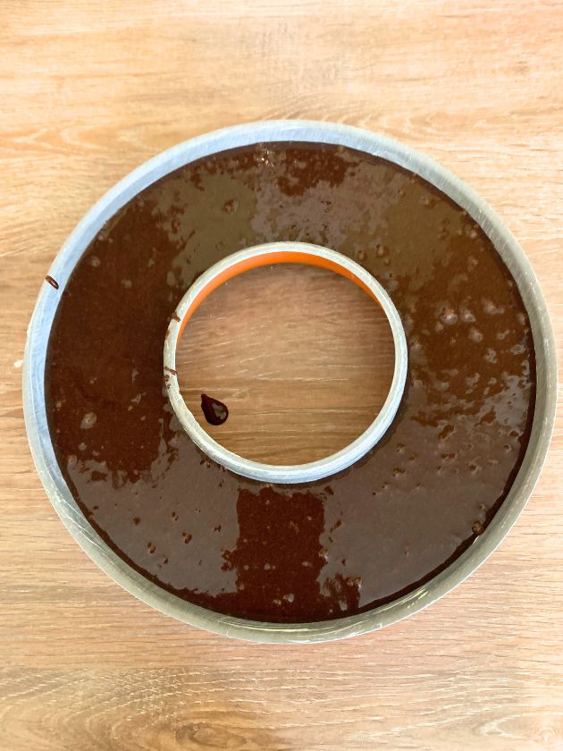 Chocolate cake batter in a ring shaped cake tin