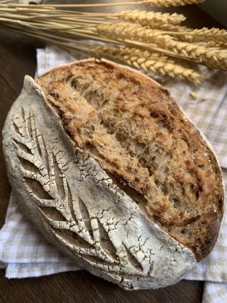 multigrain french sourdough bread on a checked tea towel
