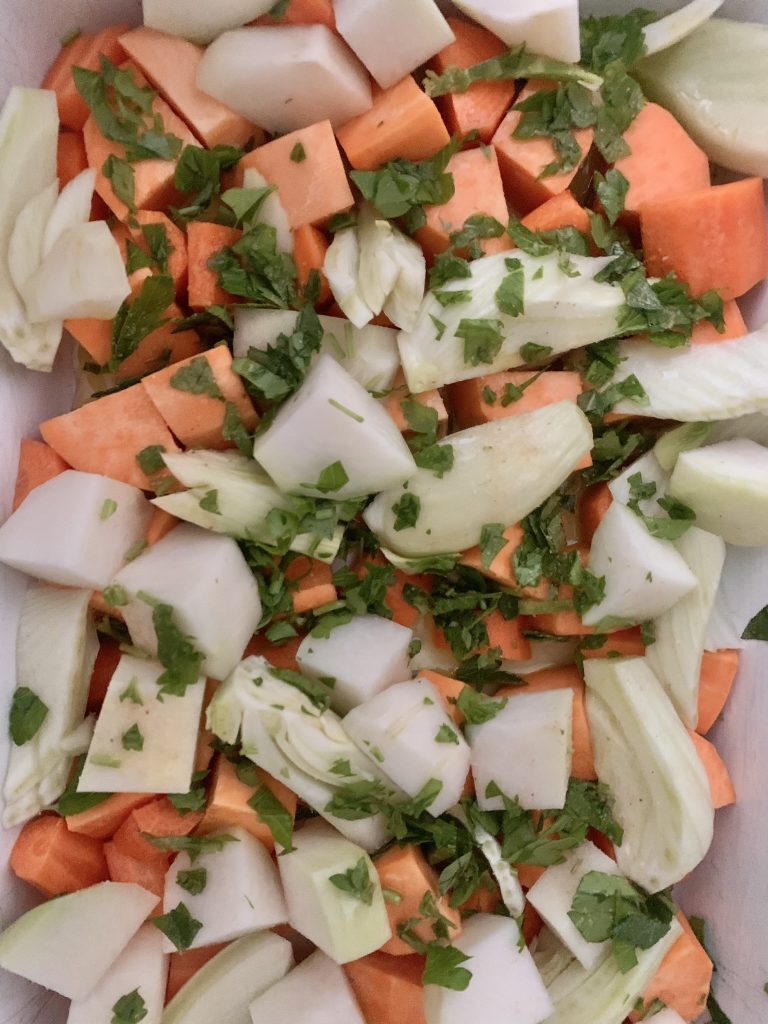 Sweet potato, carrot, fennel and kohlrabi cut up into chunks with fresh herbs