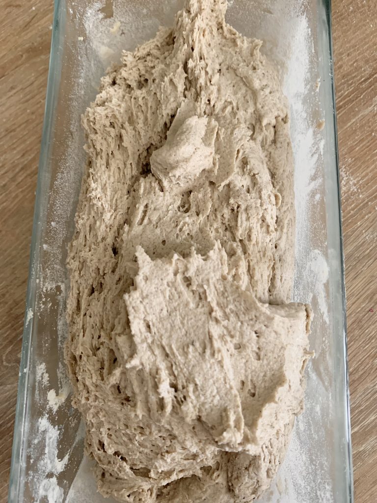 Gluten free bread dough in a loaf pan before being smoothed down