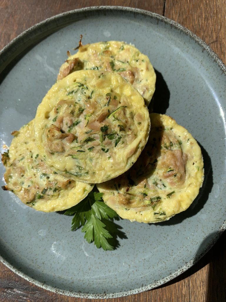 Egg and tuna muffins on a blue plate from above