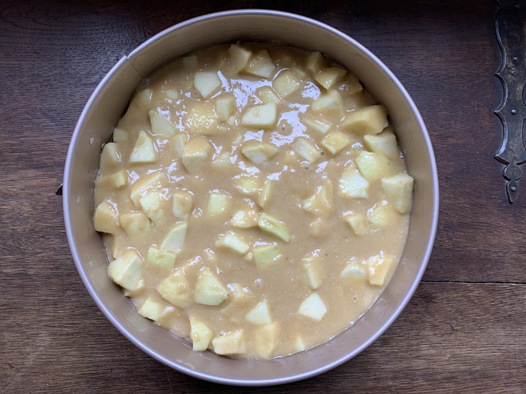 Gluten free apple cake before being baked in a spring form tin