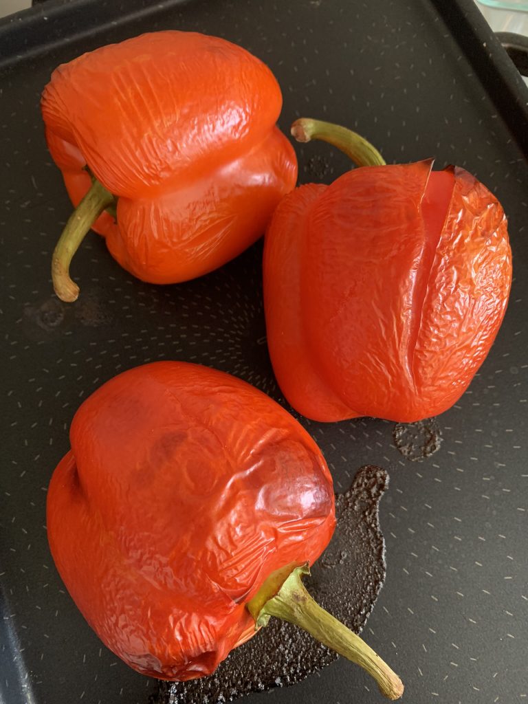 roasted red peppers on a black tray