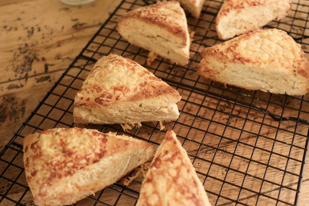 Sourdough cheese scones on a black cooking rack