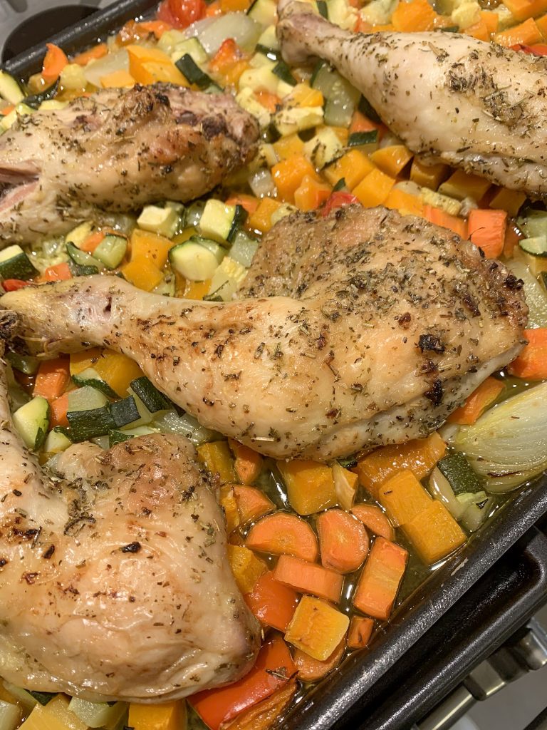 Sheet Pan Lemon and Garlic Chicken with Veggies on a black baking tray