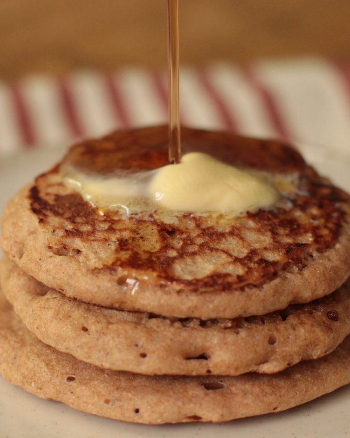 Sourdough Discard Pancakes with Fresh Milled Flour with butter and maple syrup being drizzled