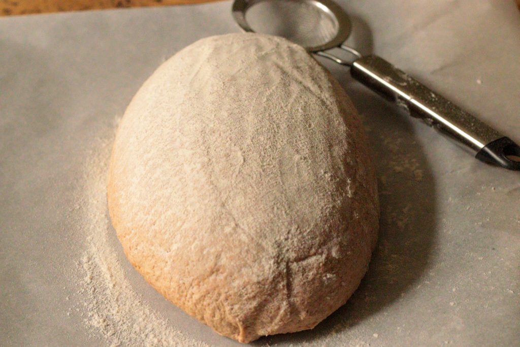 artisan loaf with fresh milled flour dusted with rice flour before baking